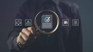 Magnifying glass over document with check mark