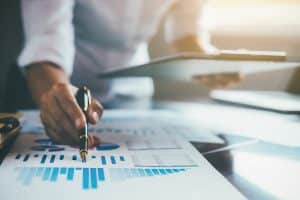 Analyzing financial data on paper with pen