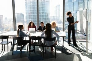 Team meeting in modern office with city view.