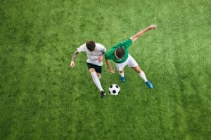 Two soccer players competing for the ball.