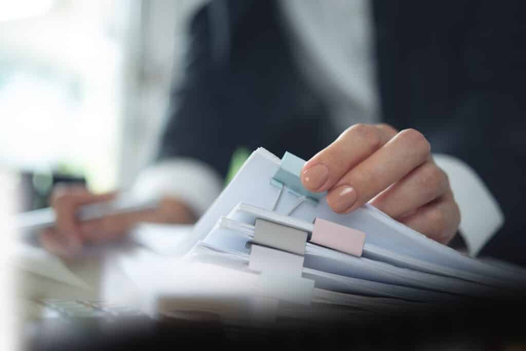 Person organizing papers with colorful clips