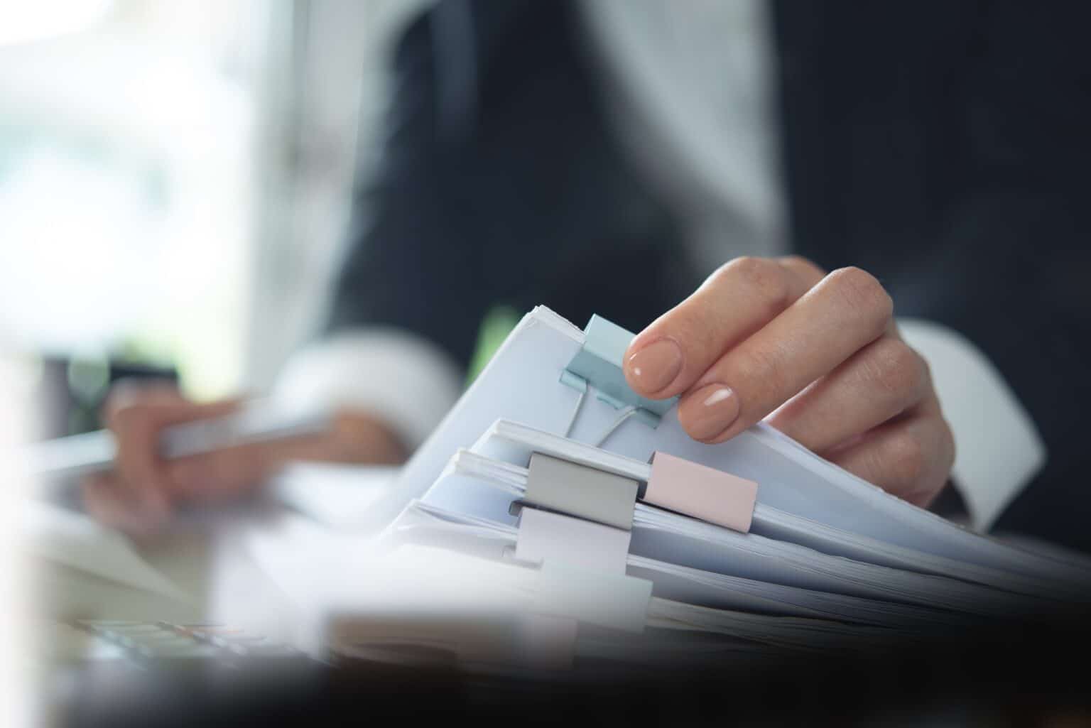 Person organizing papers with colorful clips