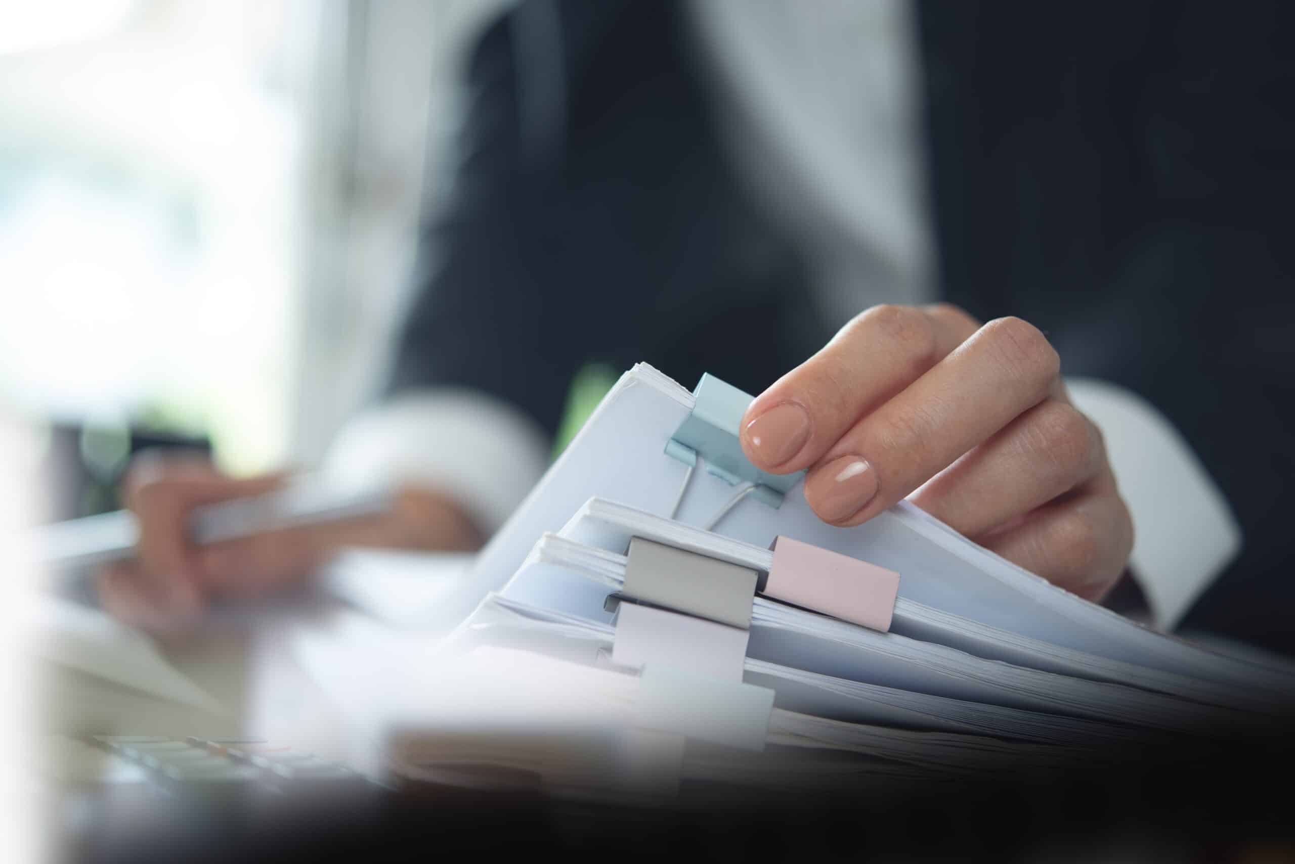 Person organizing papers with colorful clips