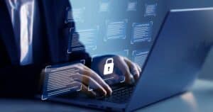 Person typing on a laptop with security graphics