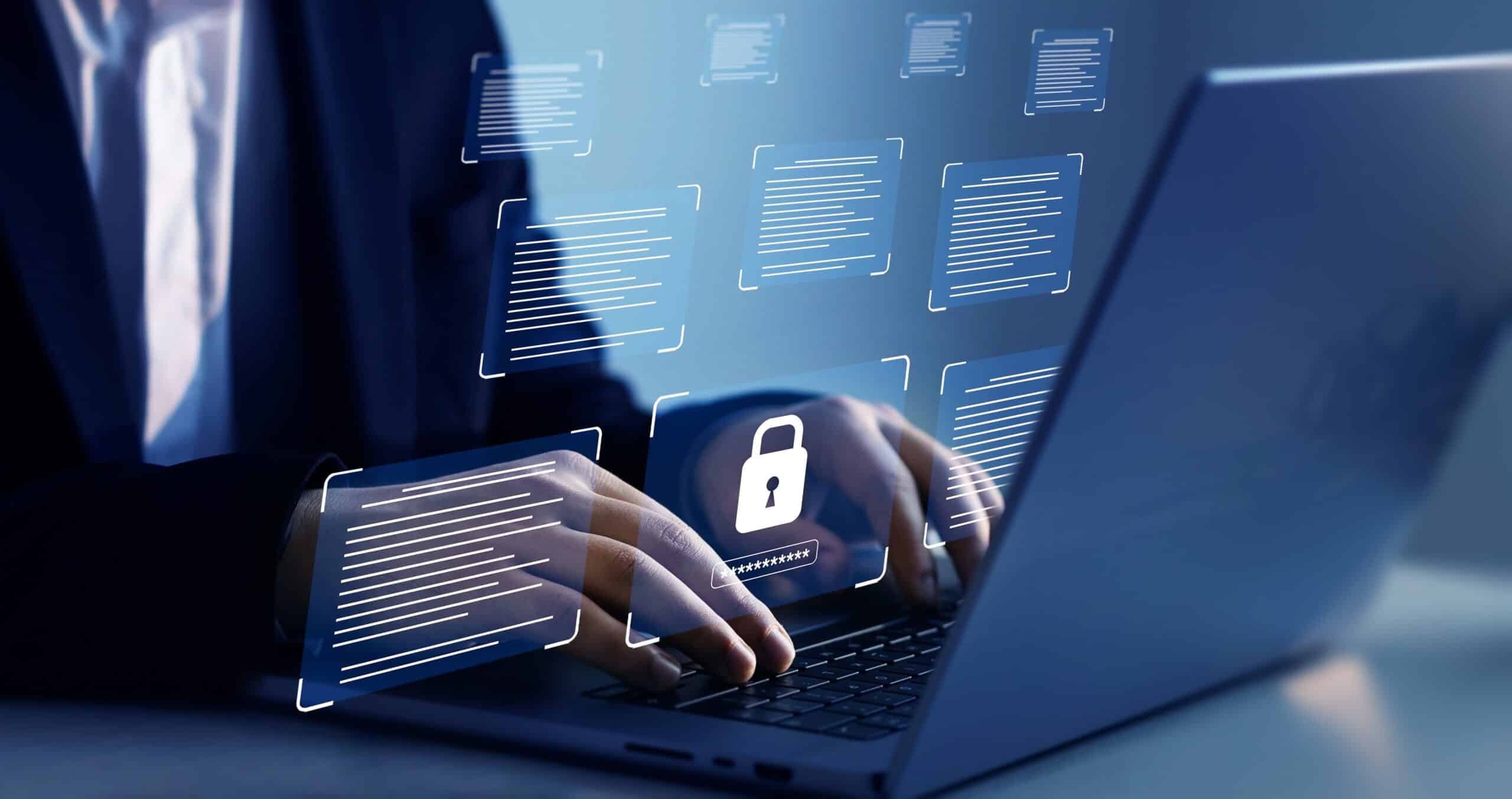 Person typing on a laptop with security graphics
