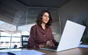 Woman working on laptop in modern office