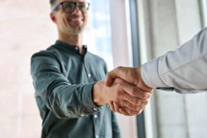 Two people shaking hands in agreement.