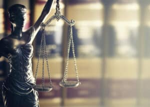 Blindfolded Lady Justice statue with scales