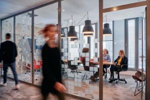 Modern office workspace with people in a meeting.