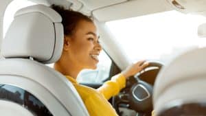 Smiling woman driving a car