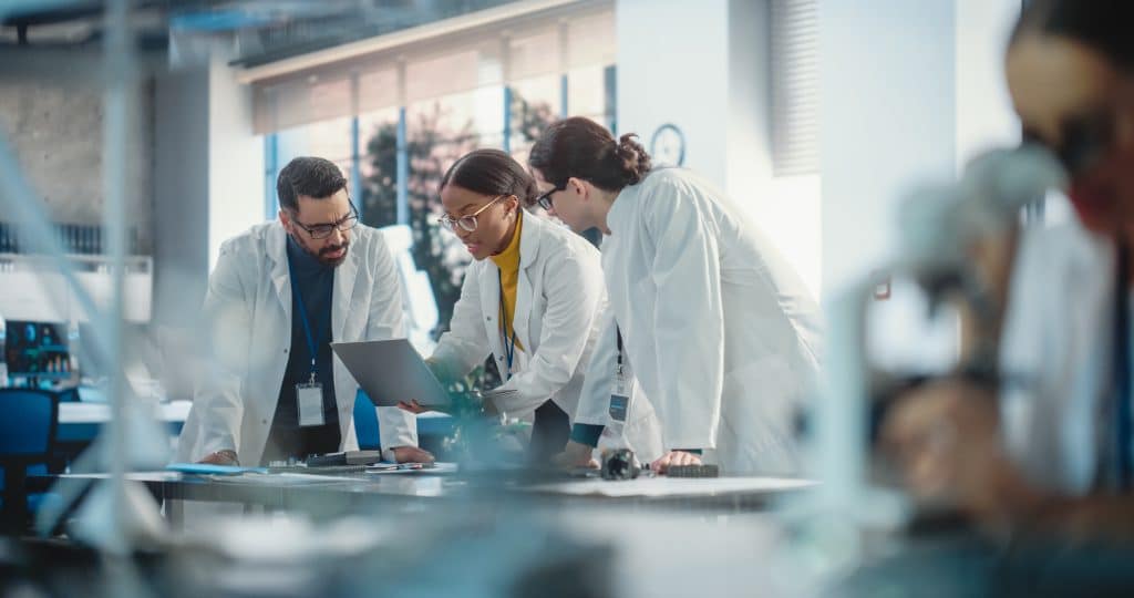 Scientists collaborating in a modern laboratory environment.