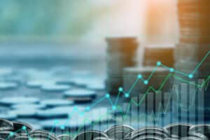 Coins with a rising graph indicating financial growth