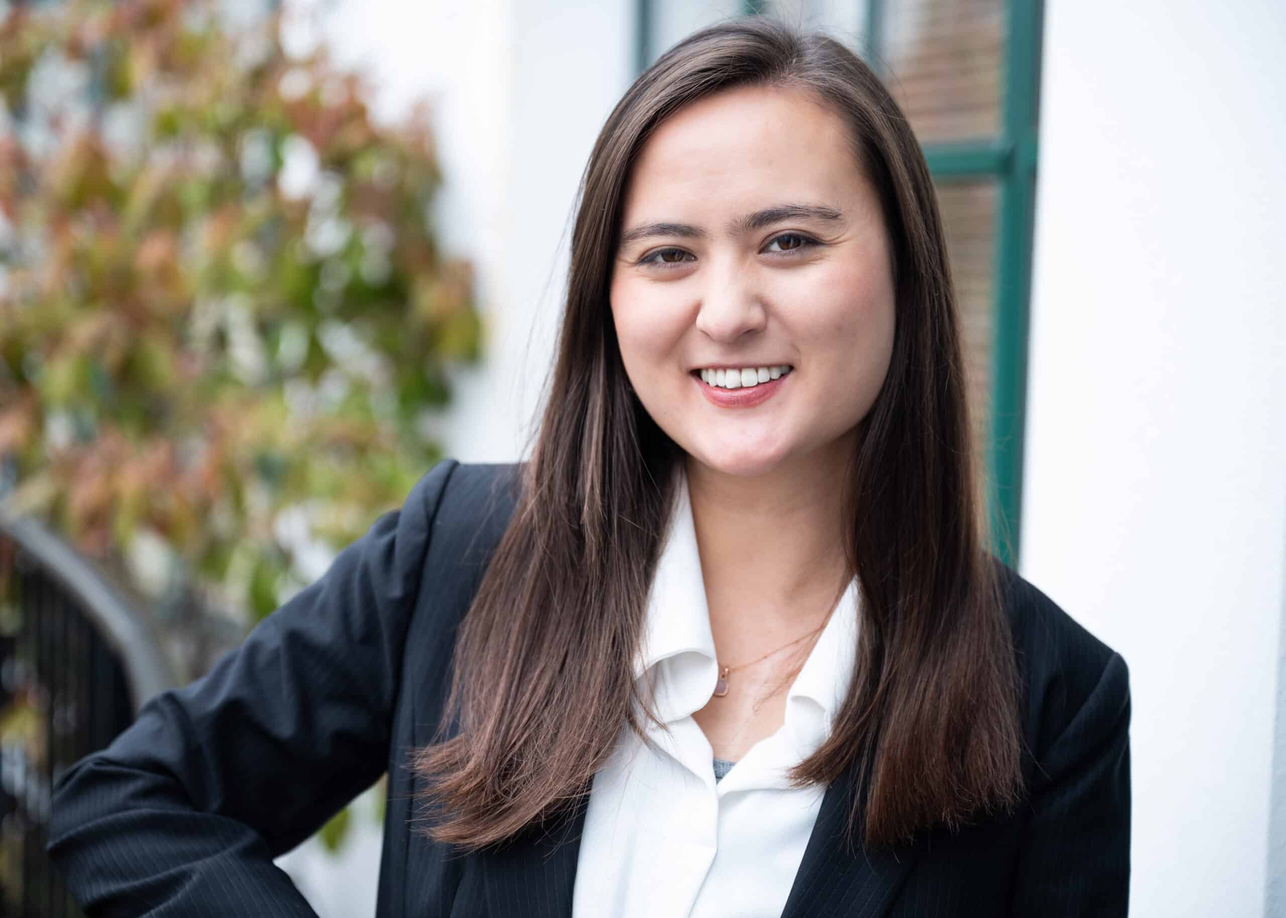 Smiling young woman in a professional suit.