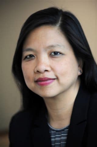 Professional portrait of a smiling woman.