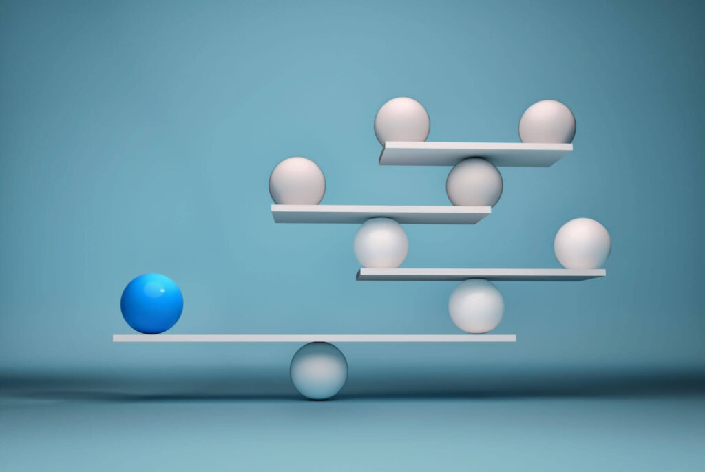 Balancing spheres on layered shelves against blue background.