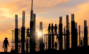 Silhouette of construction workers at sunset