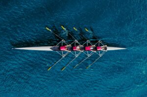 Rowing team in a boat on calm water