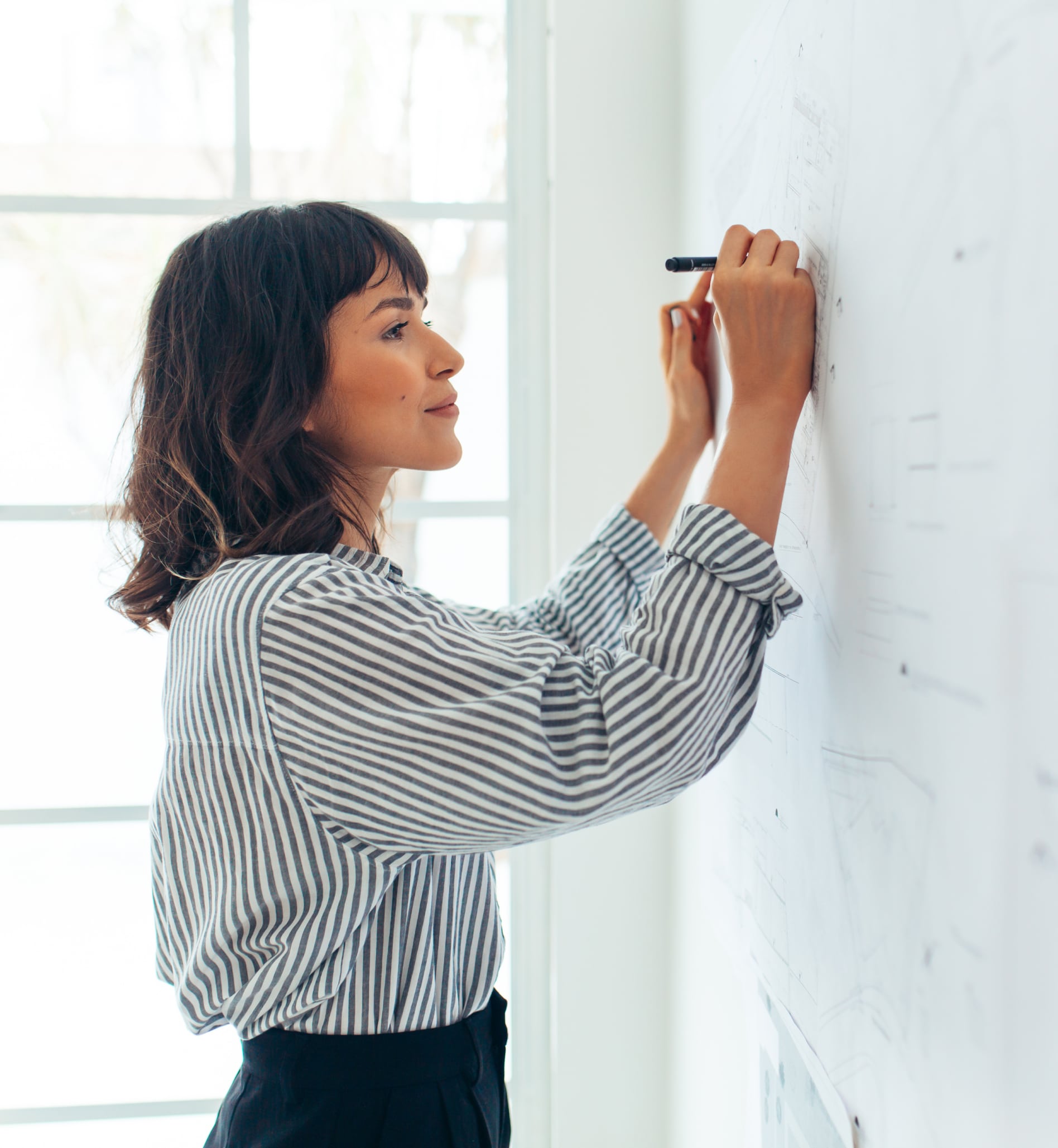 woman writing on a whiteboard