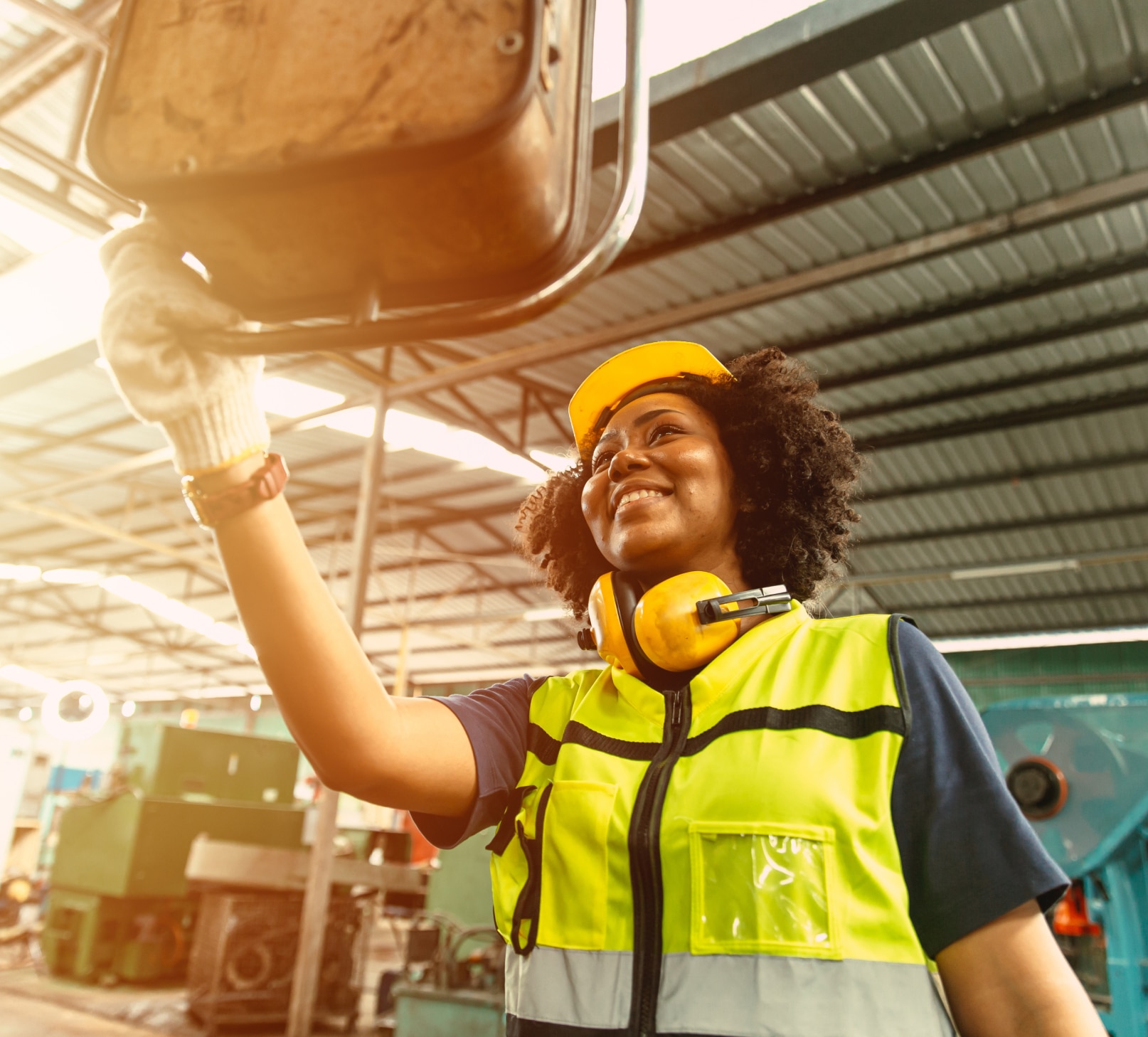 Woman in a hard hat and high visibility jacket working on a construction site