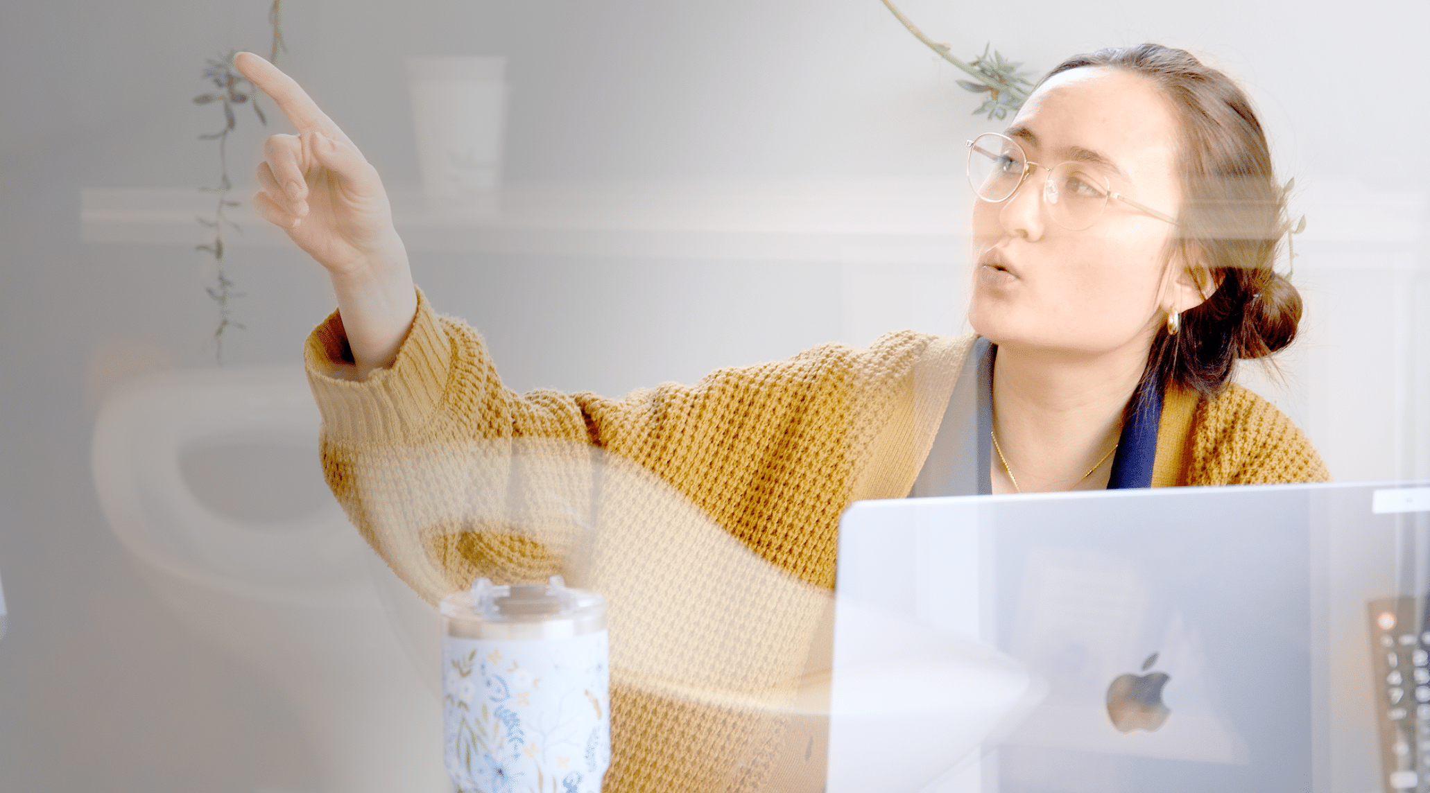 Person pointing while speaking during a discussion.