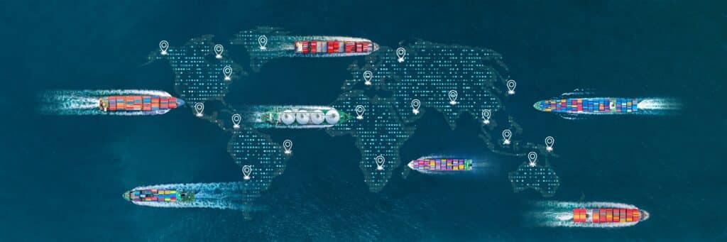 Cargo ships on the sea with an overlay of a digital global map