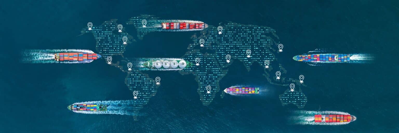 Cargo ships on the sea with an overlay of a digital global map