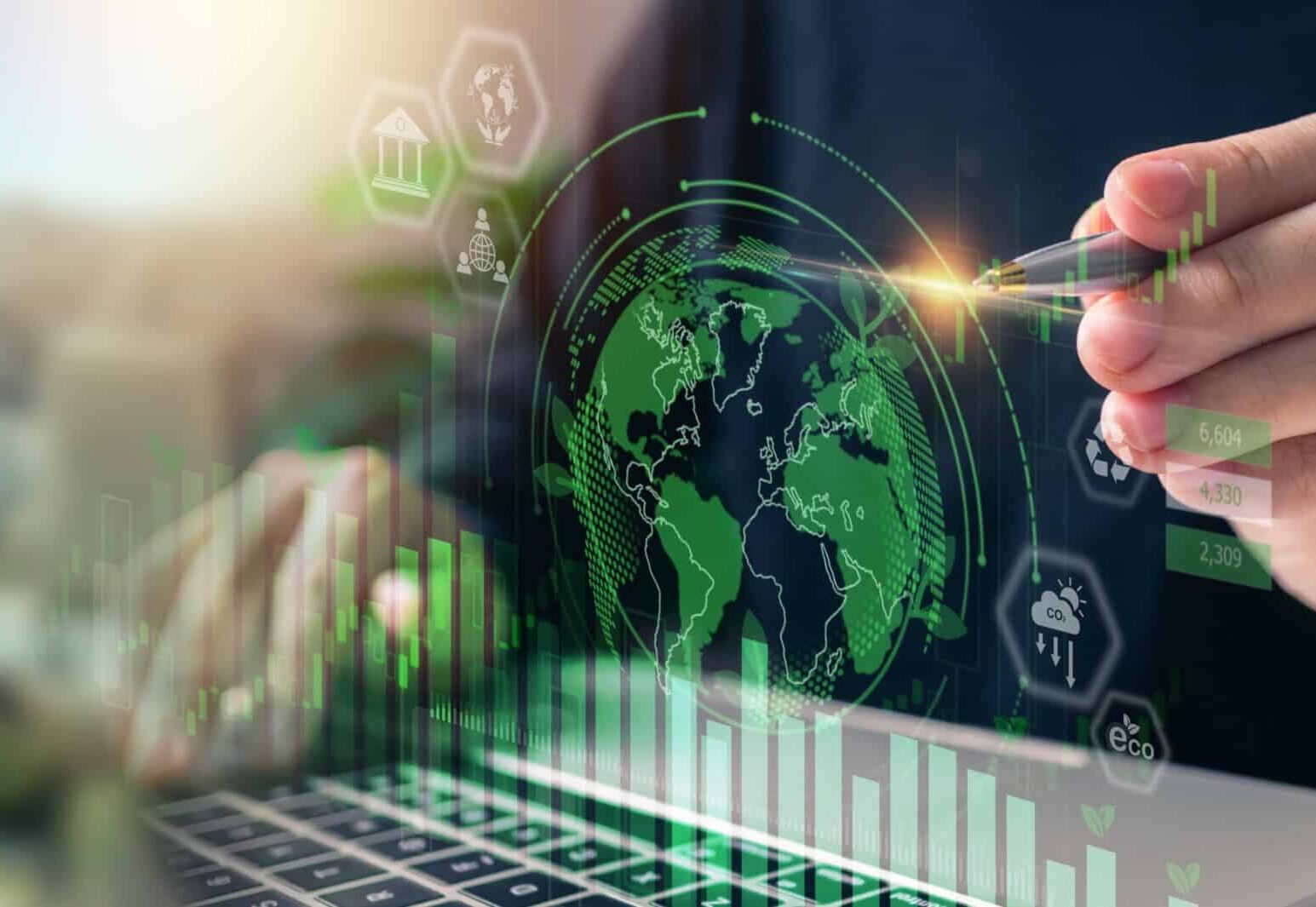 Hand using a laptop with digital environmental graphics.