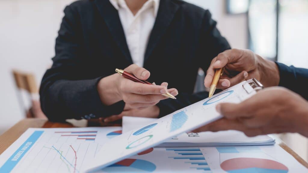 Business meeting with charts and graphs.