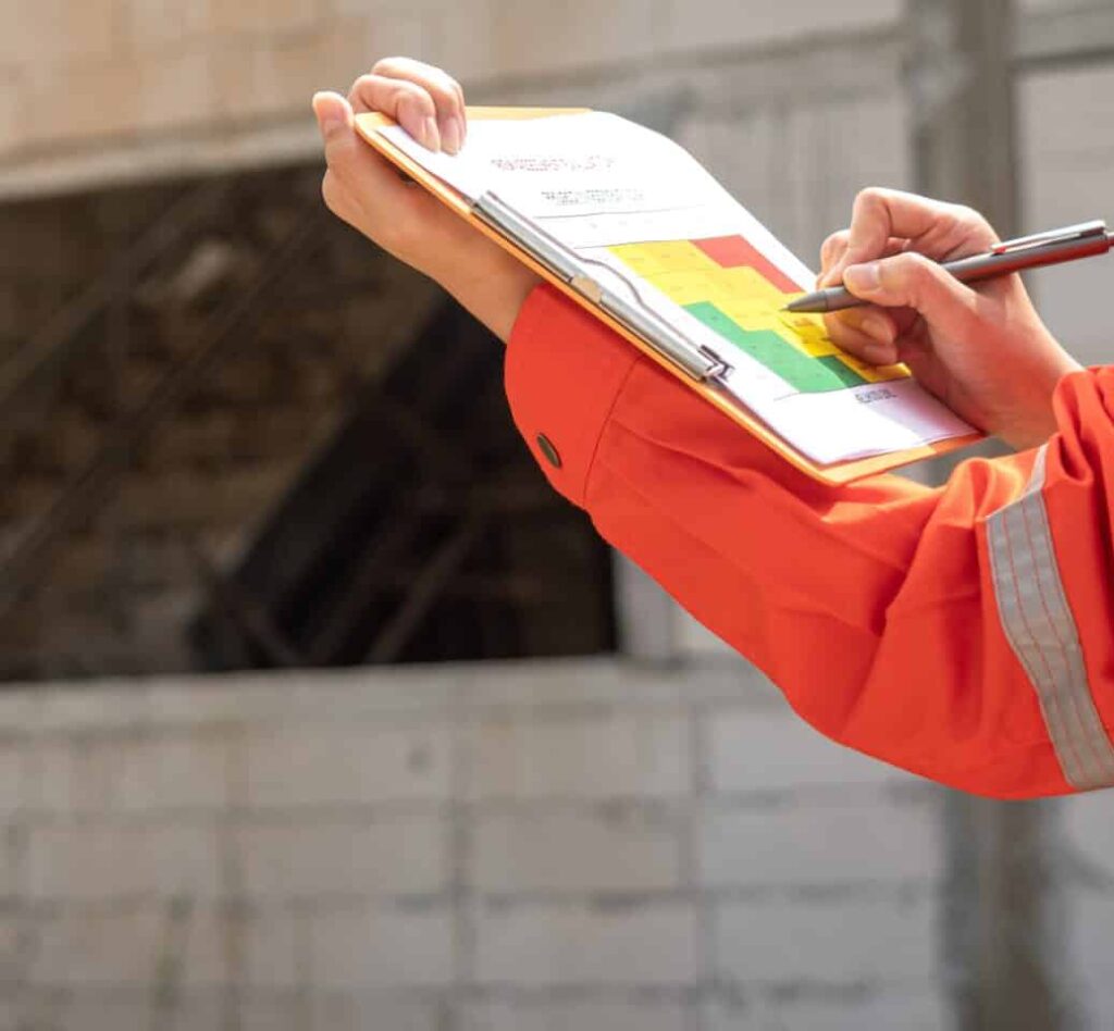 Person in safety gear reviewing construction plans