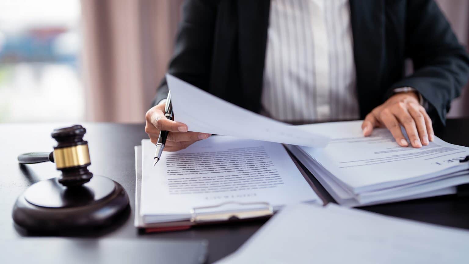 Person reviewing legal documents with a gavel