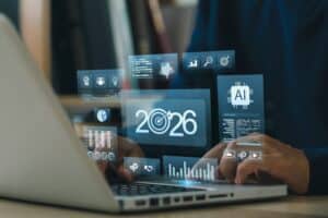 Person using laptop with futuristic data interface.