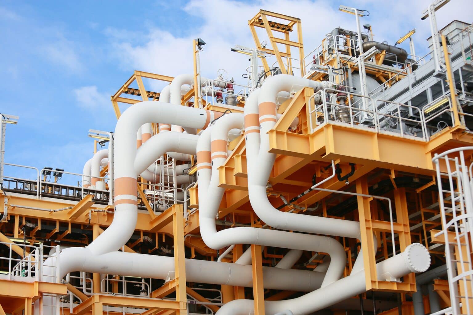 Industrial pipes and structure against blue sky