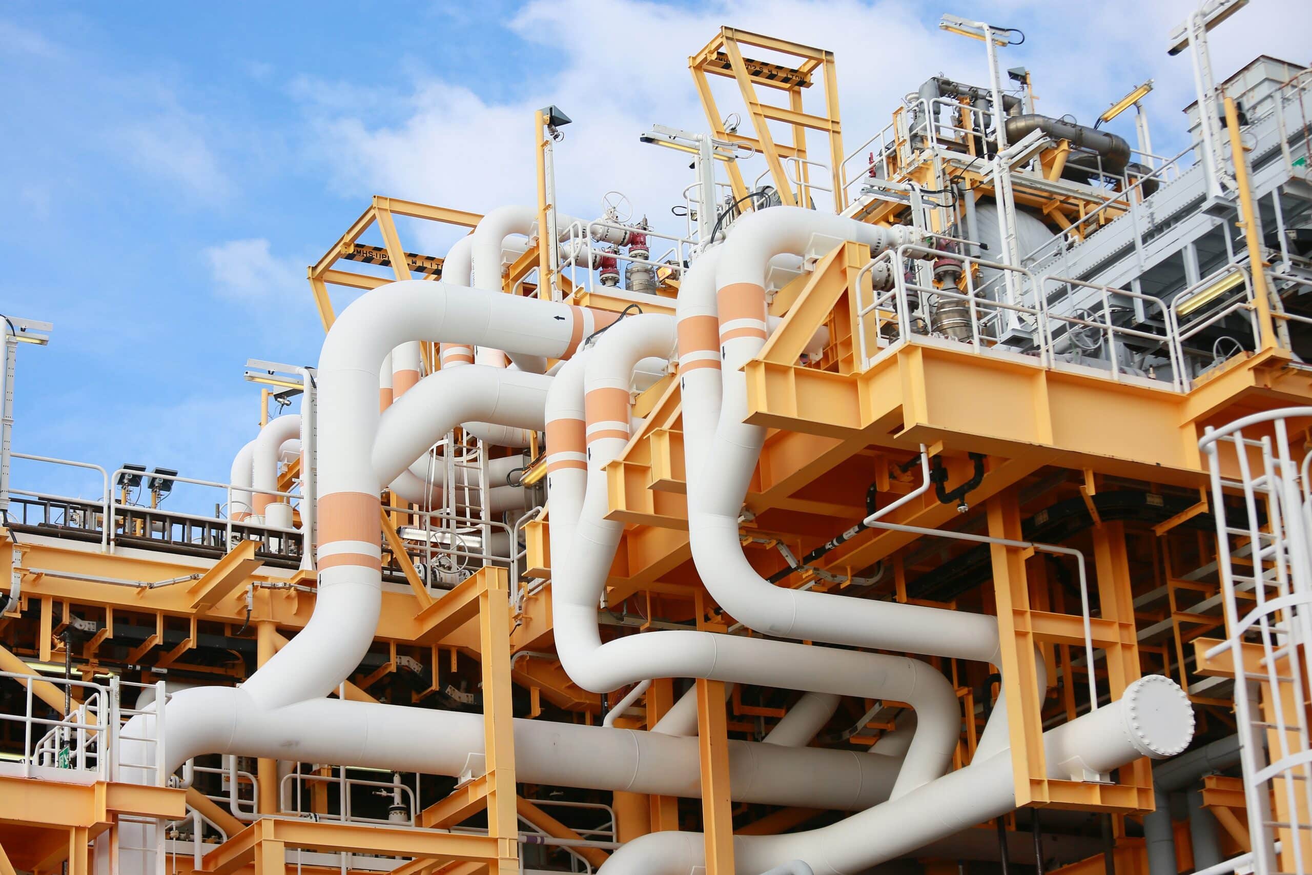 Industrial pipes and structure against blue sky