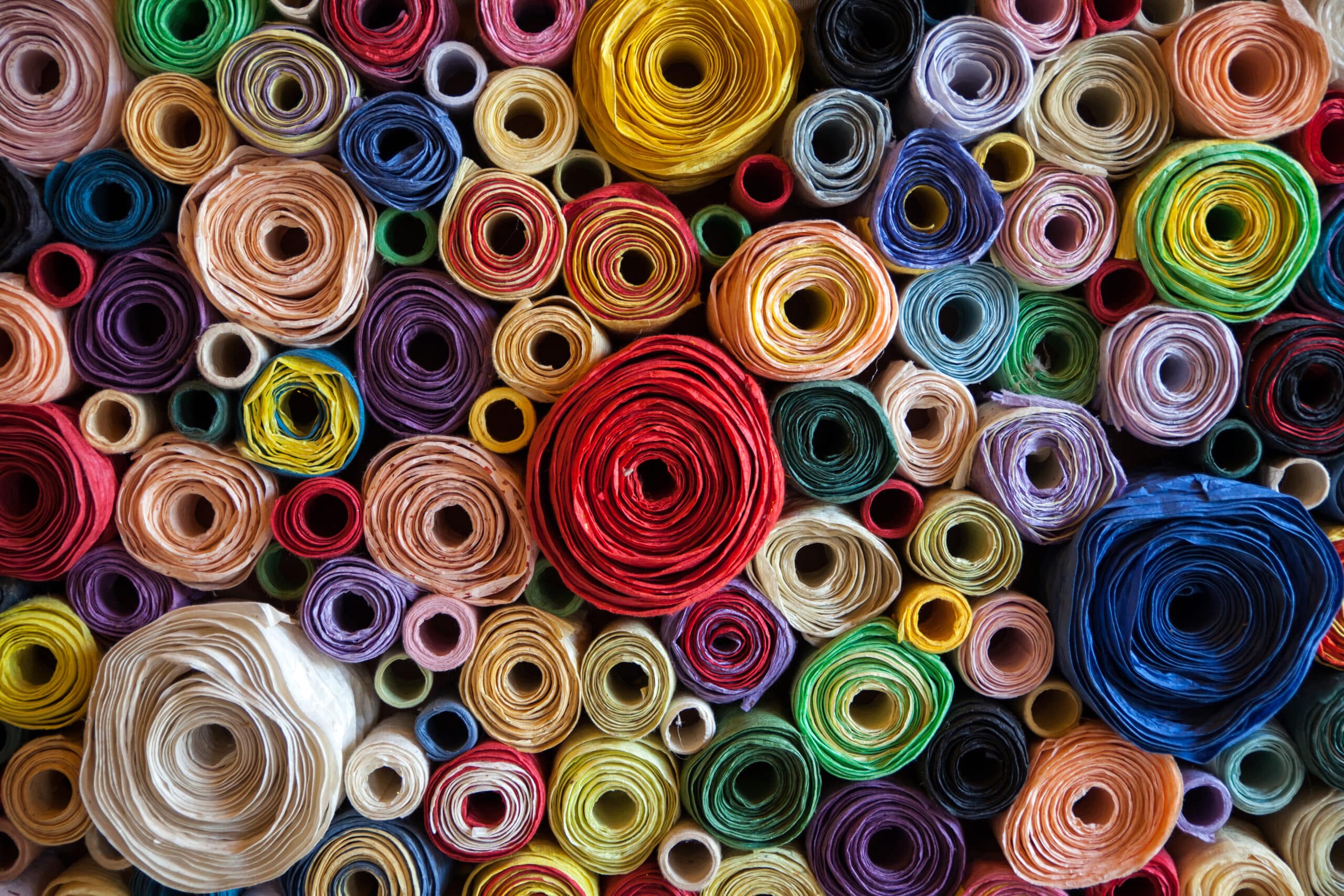 Colorful rolls of paper stacked tightly together