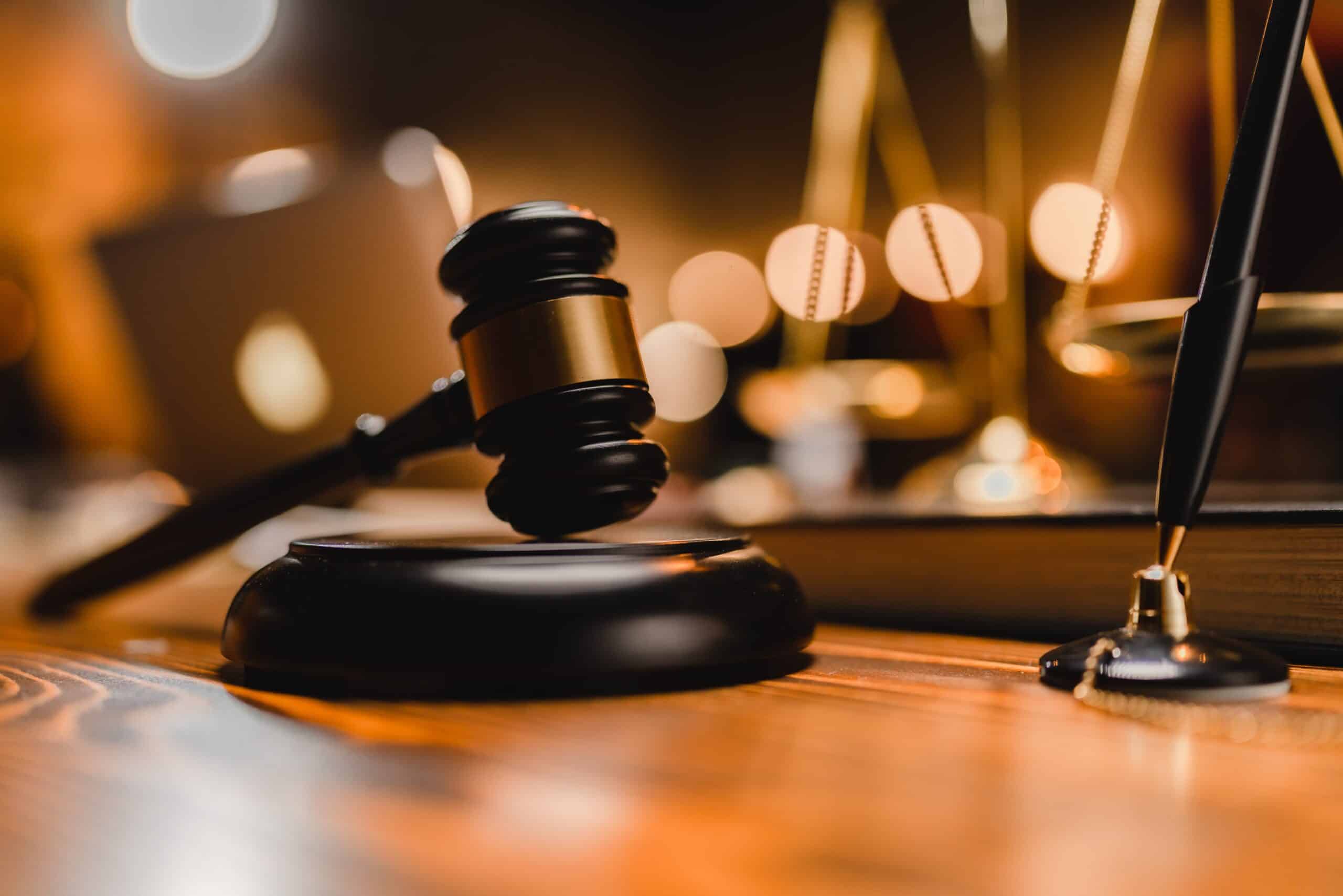 Judge’s gavel and scales of justice on desk